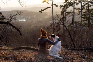 A girl with a dog on a hike