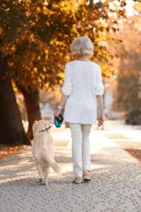 Senior woman walking a dog