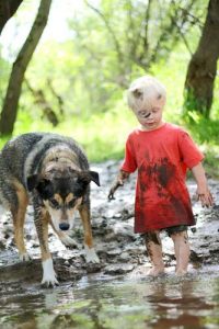 kid and dog in mud