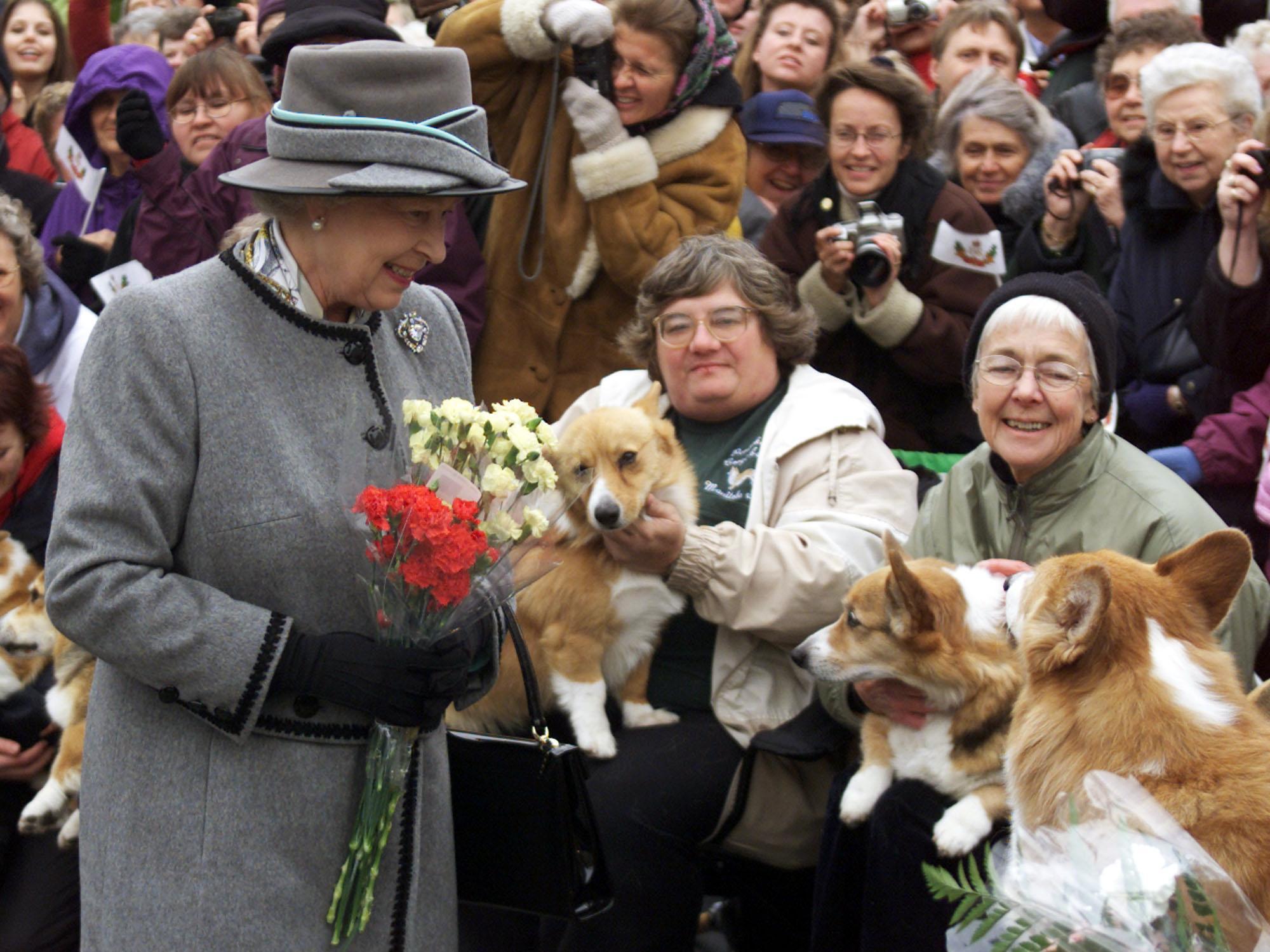 Queen Elizabeth II talks with members of the Manit