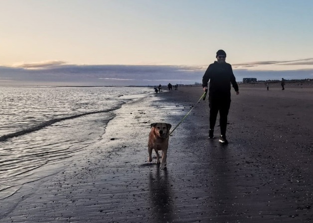 Simon and Bella walking at the beach