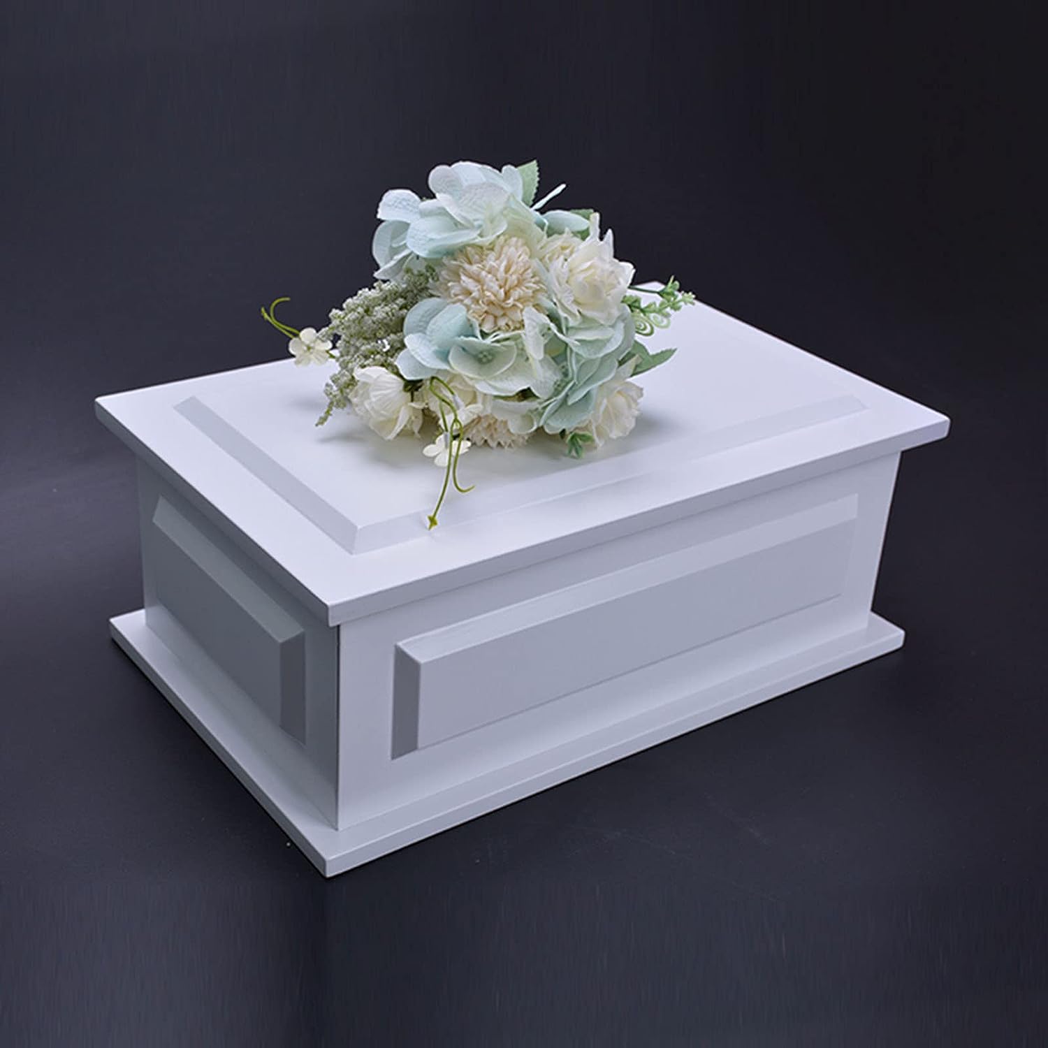 White pet casket with flowers on top